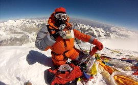 Edita holding her fathers photo on the summit of Mt Everest