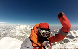Edita waving hand on the summit of Mt Everest